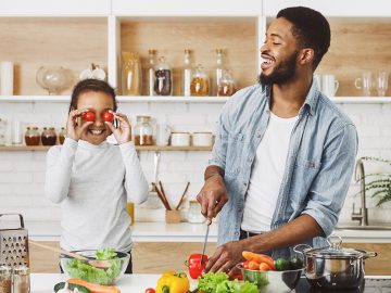 positive-dad-and-daughter-having-fun-on-kitchen